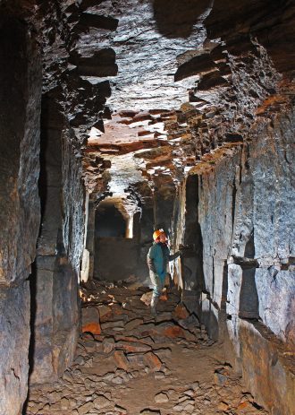 CAHG Photo 3 Daisy Knoll Underground Stone Quarry, Longnor, Staffordshire. Looking south-west along the largest extraction gallery, with the original roadway surface partly covered with stone blocks fallen from the roof | © Mat & Niki Adlam-Stiles