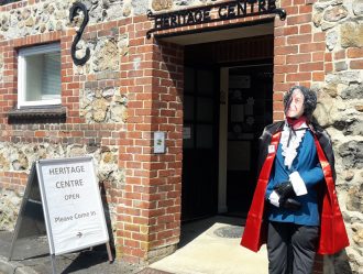 Aldbourne Heritage Centre 2018  for the Aldbourne Churches Together Scarecrow Trail.  This character represents a famous visitor to the village in 1971.  Clues: he drove a yellow car and battled Daemons!