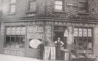 Man and boy outside shop in McDonnell Street, Belfast