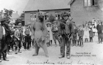 Dancing bear at Massingham school, 1910.