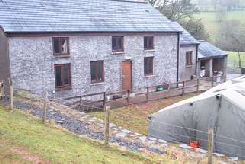 Myndd_Epynt A former farmhouse in Myndd Epynt, now with a military tent outside its front door