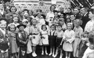 The Coronation Queen on her throne with other children during the coronation celebrations in Aston, 1953