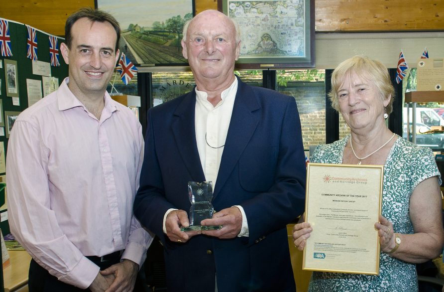 marden Dr Nick Barratt presenting the Community Archive of the Year Award 2011, in Marden, to David McFarland and Eurice Doswell of the Marden History Group.
