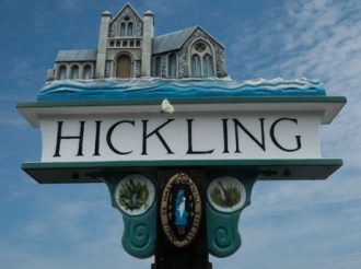 Hickling village sign, showing church and the name Hickling | Photo by Martin Johns