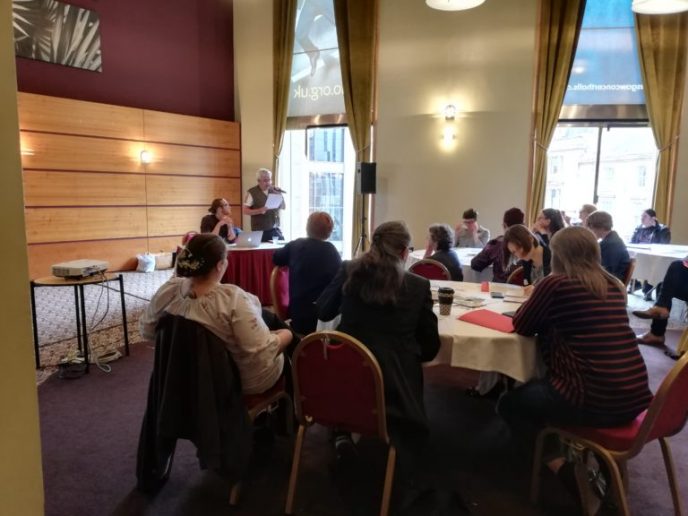 Break-out-session-1-768x576 The conference included several breakout sessions, including this one about migration stories in the LGBT+ community, with Ourstory Scotland. A number of people are sat round a table | Community Archives and Heritage Group